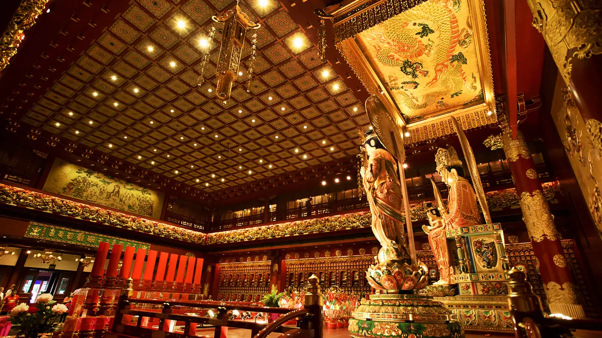 Chinatown — The gilded interior hall of the Buddha Tooth Relic Temple, with its coffered ceiling and dragon banner