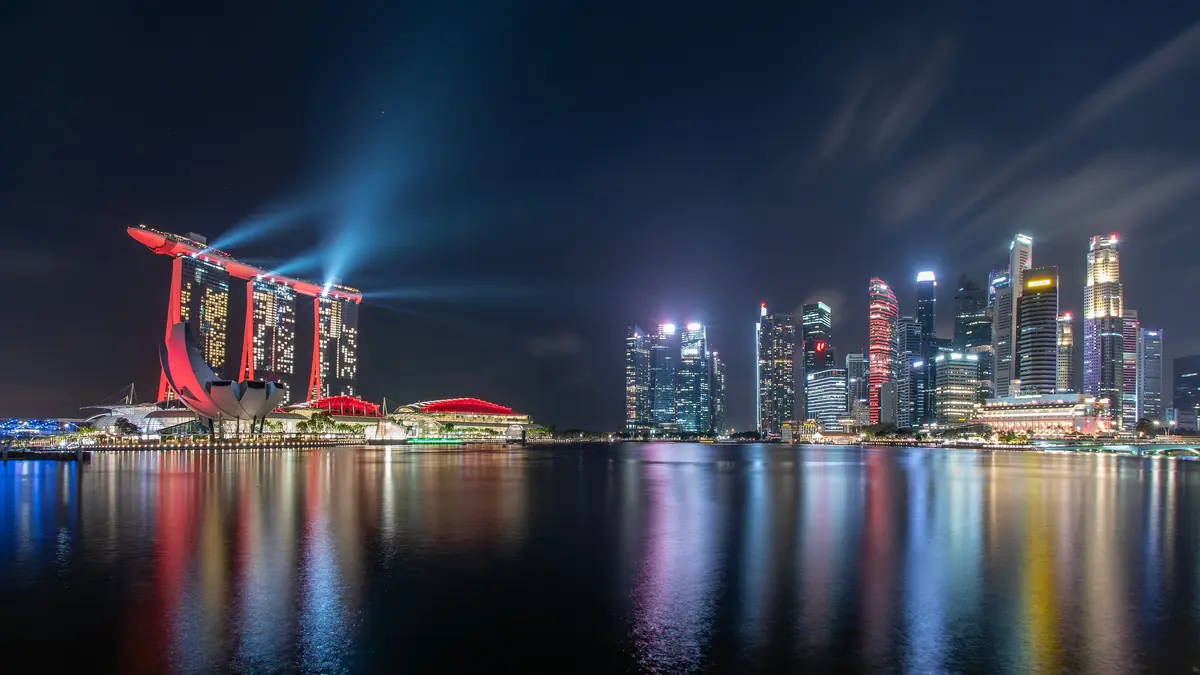 Marina Bay Sands — Marina Bay Sands during the Spectra light show at night, its beams crossing above the bay