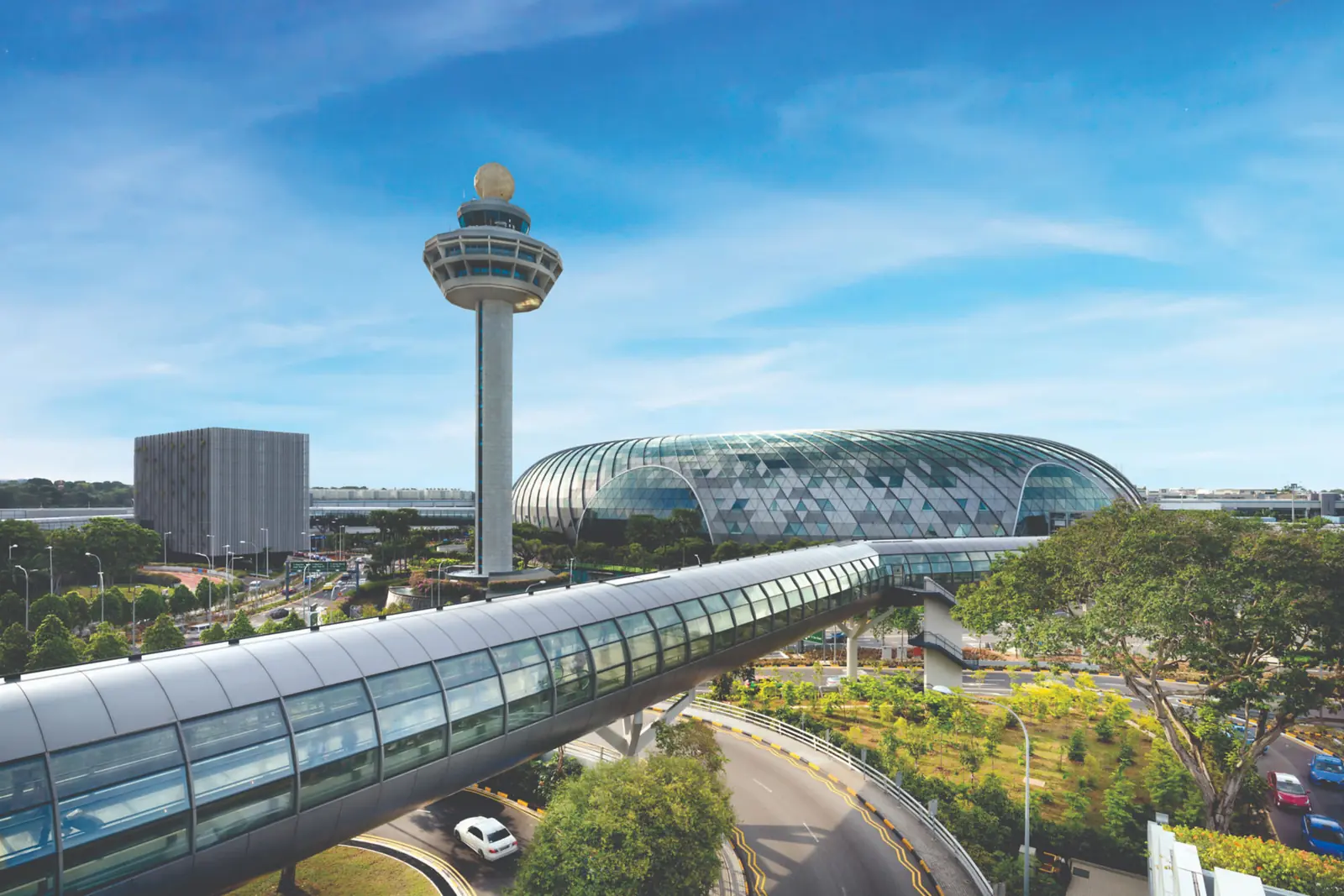 Changi Airport — Changi Airport's control tower rising beside the glass dome of Jewel Changi Airport