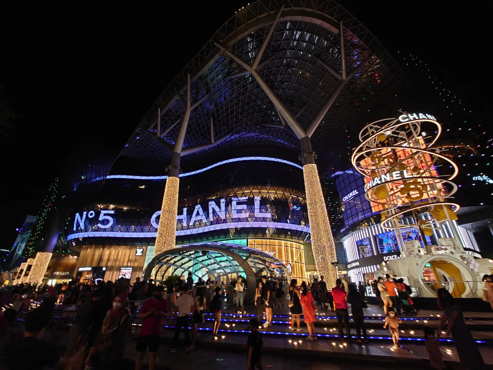 Orchard Road Singapore at dusk, looking down the shopping strip beneath the tree canopy