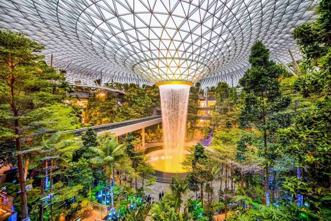 The Rain Vortex indoor waterfall falling through the glass dome at Jewel Changi Airport, Singapore